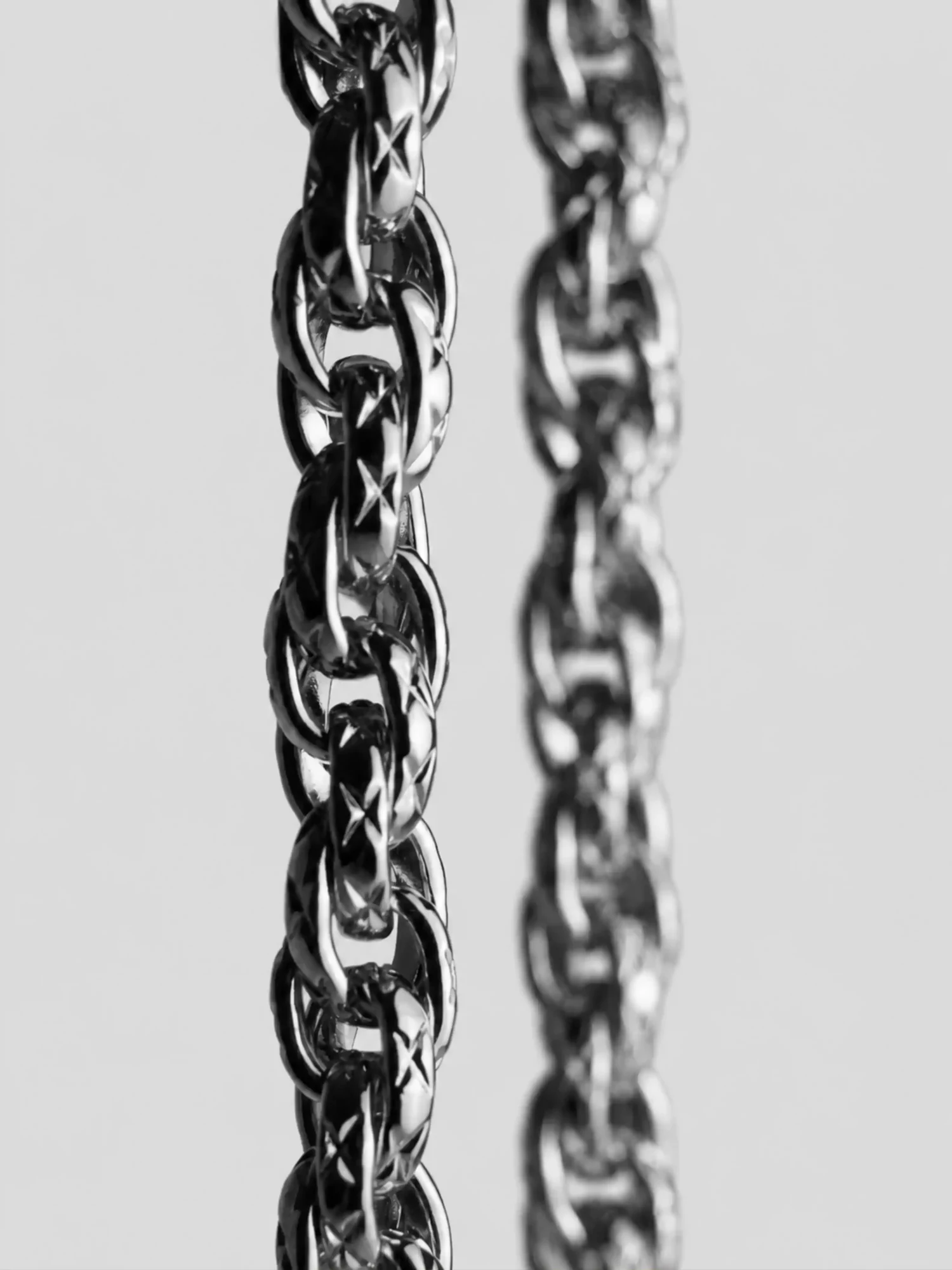 Links of the silver chain strap on the Éclat bag, macro