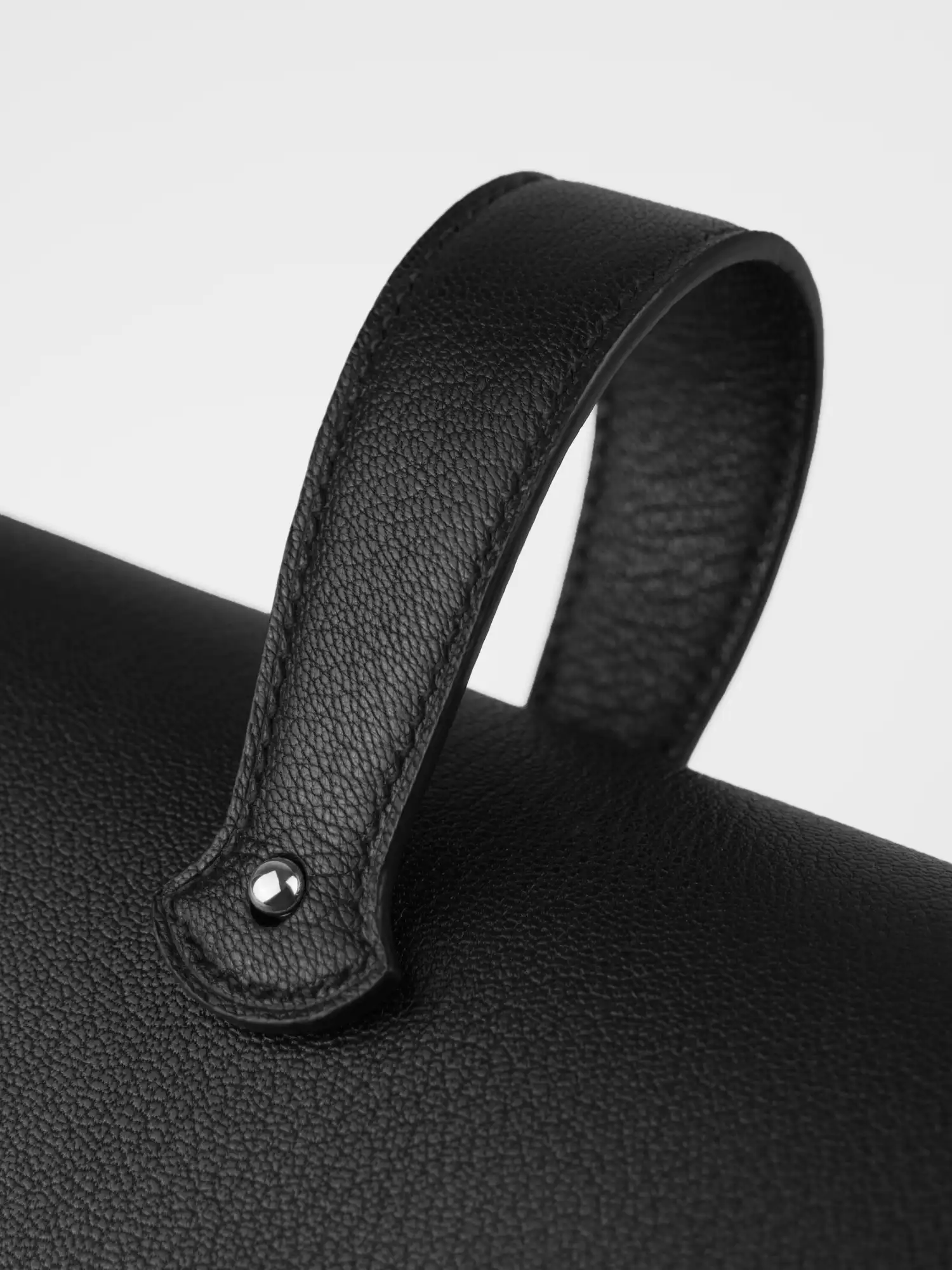 Handle of the Éclat bag, silver hardware, close-up on the attachment point and rivet