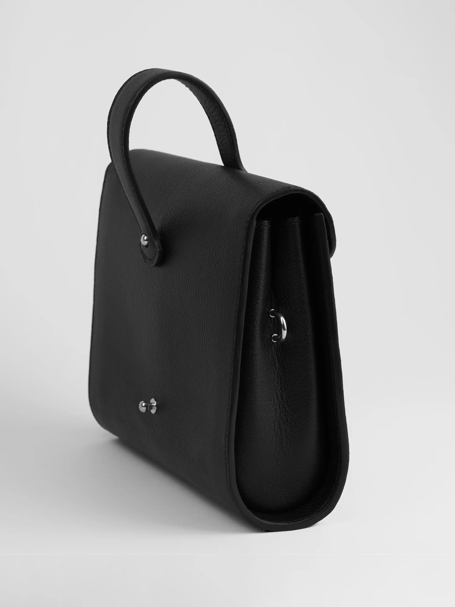 Éclat bag in black goatskin, silver hardware, three-quarter back view