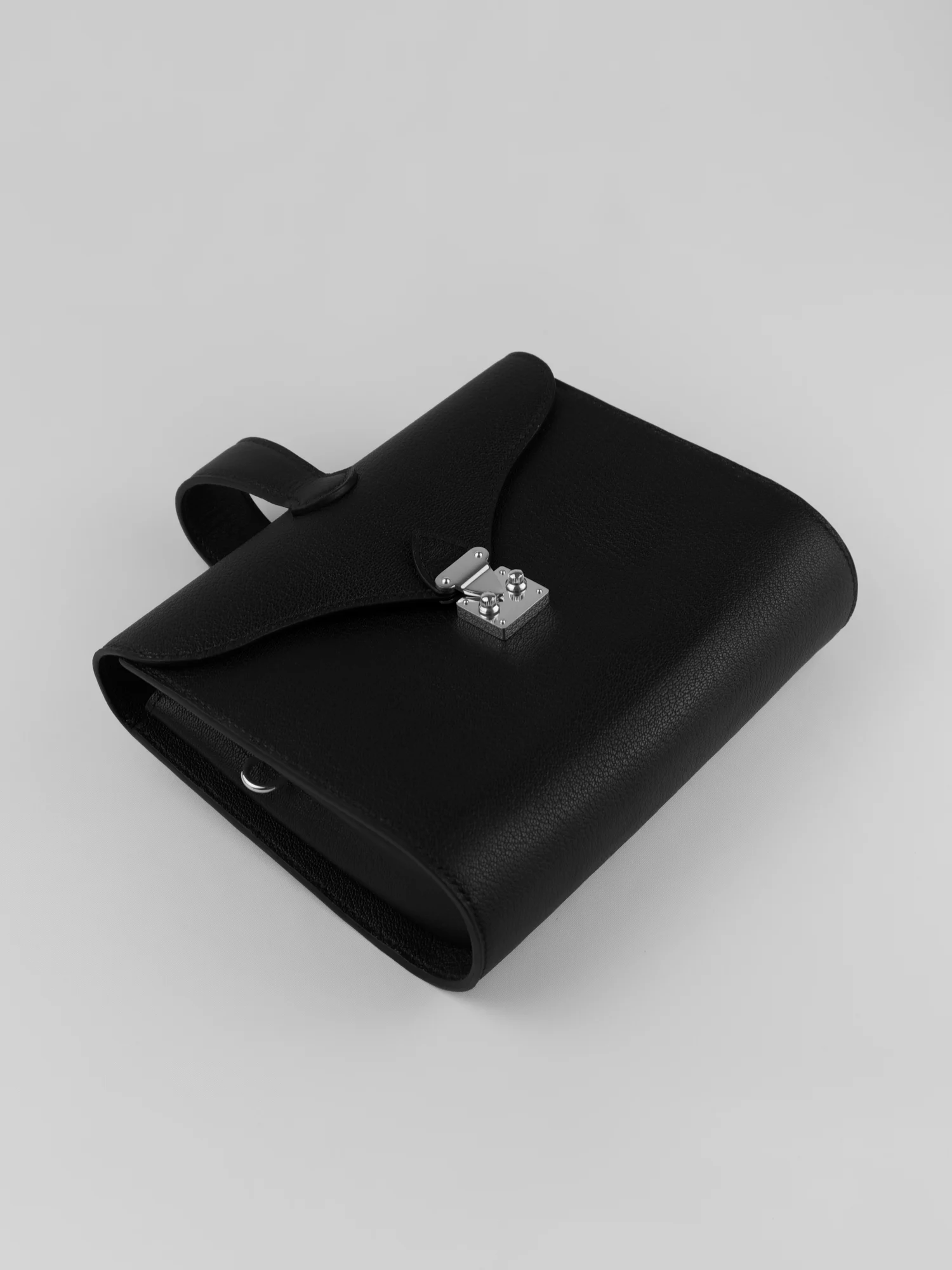Éclat bag in black goatskin, silver hardware, top view, leather-lined interior